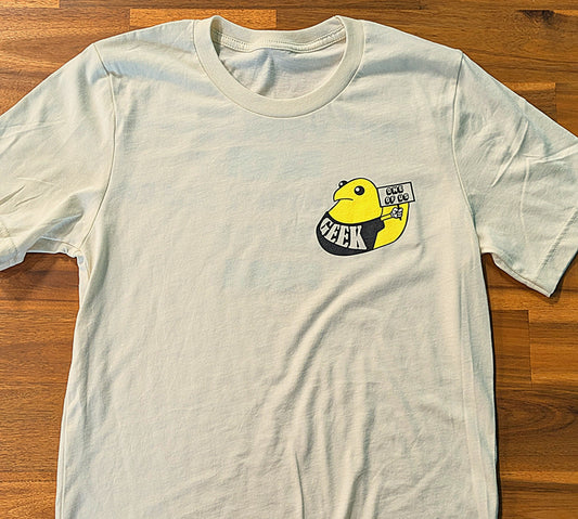 Gray t-shirt with a yellow rubber duck graphic and 'GEEK' text on a wooden surface