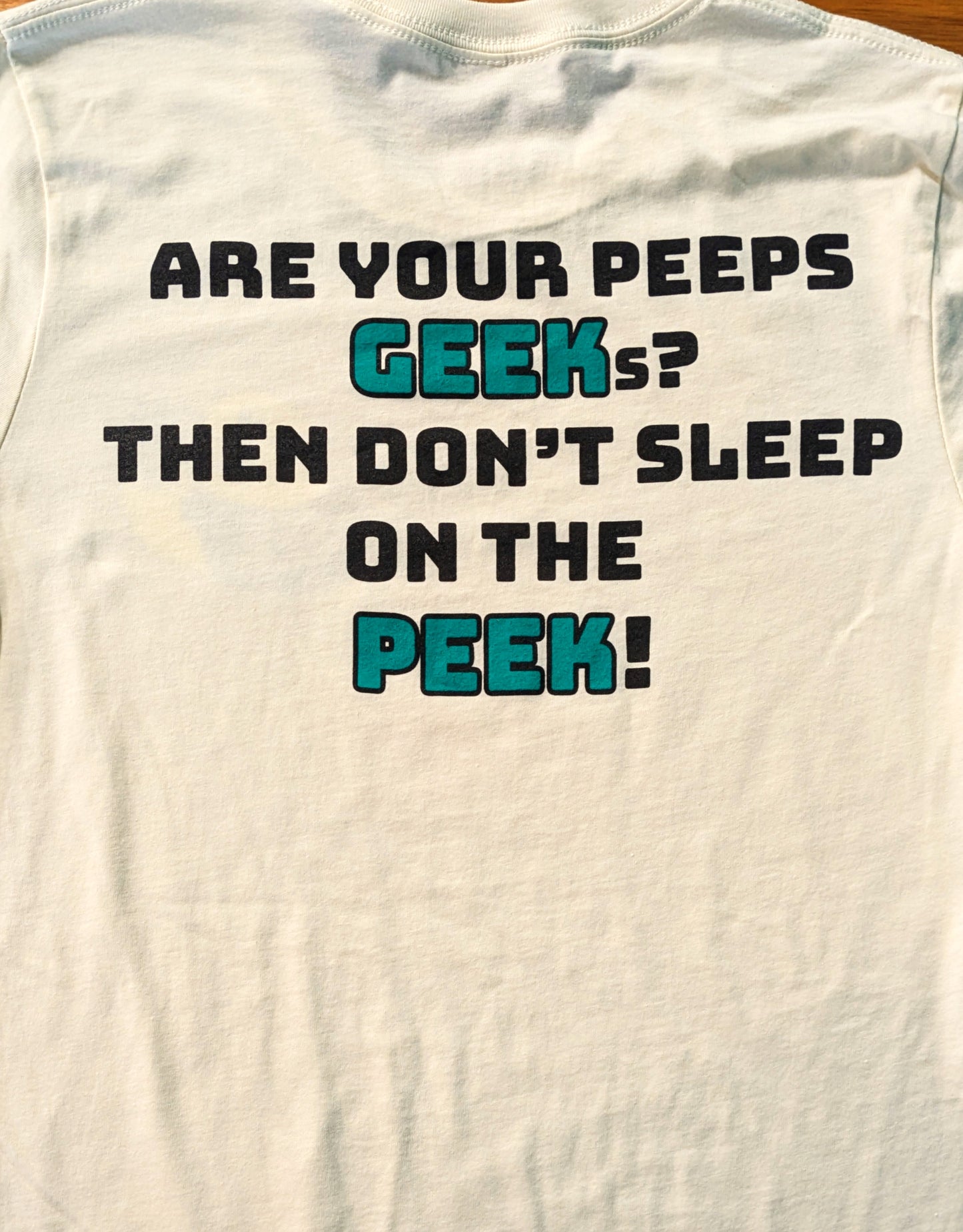 White tank top with humorous text design on a plain background