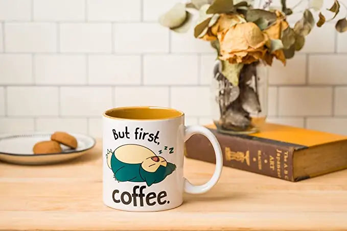 Pokemon Snorlax I Need Coffee "But First Coffee" 20oz Ceramic Mug DIsplayed on Table